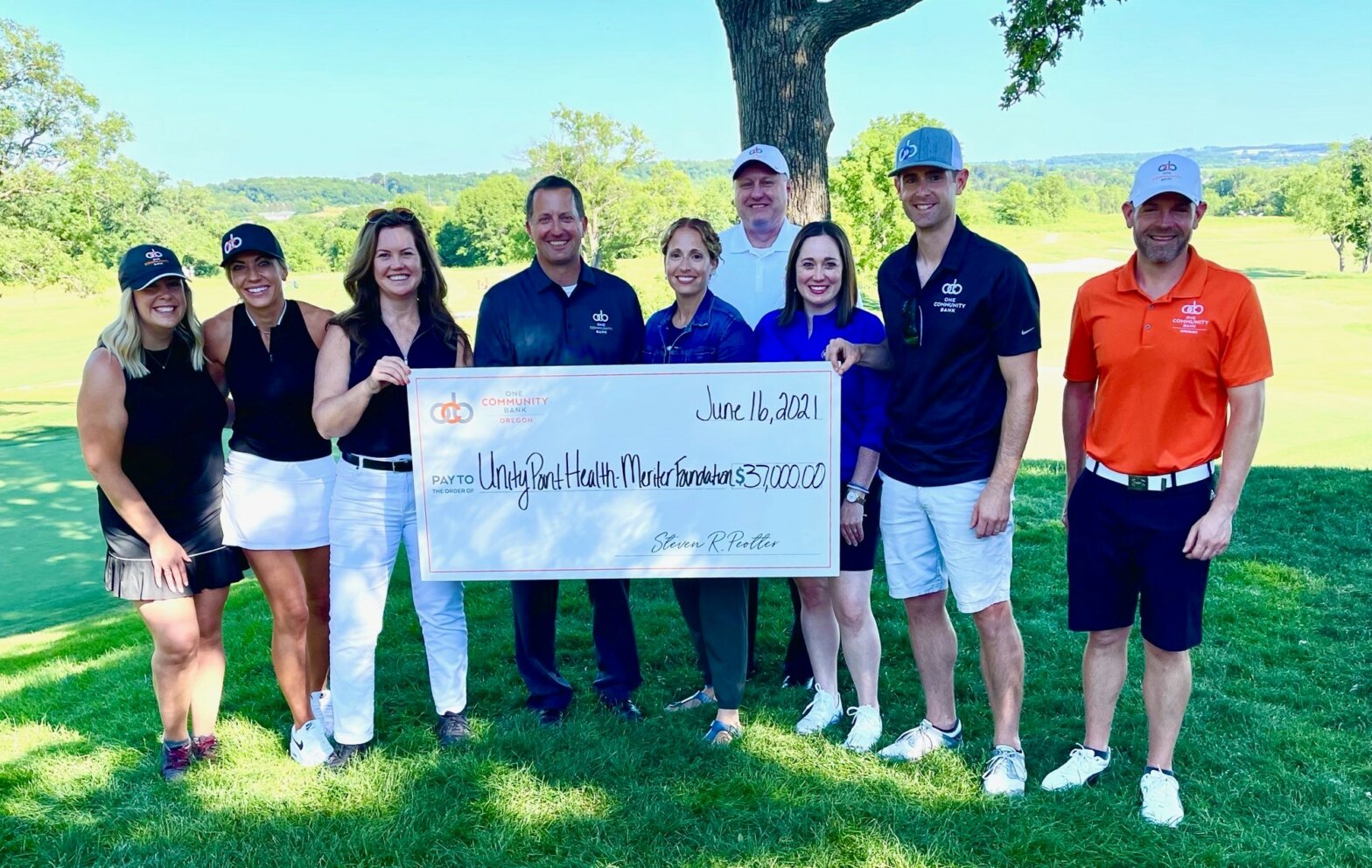 Steve Peotter and OCB Colleagues holding check for Unity Point Health