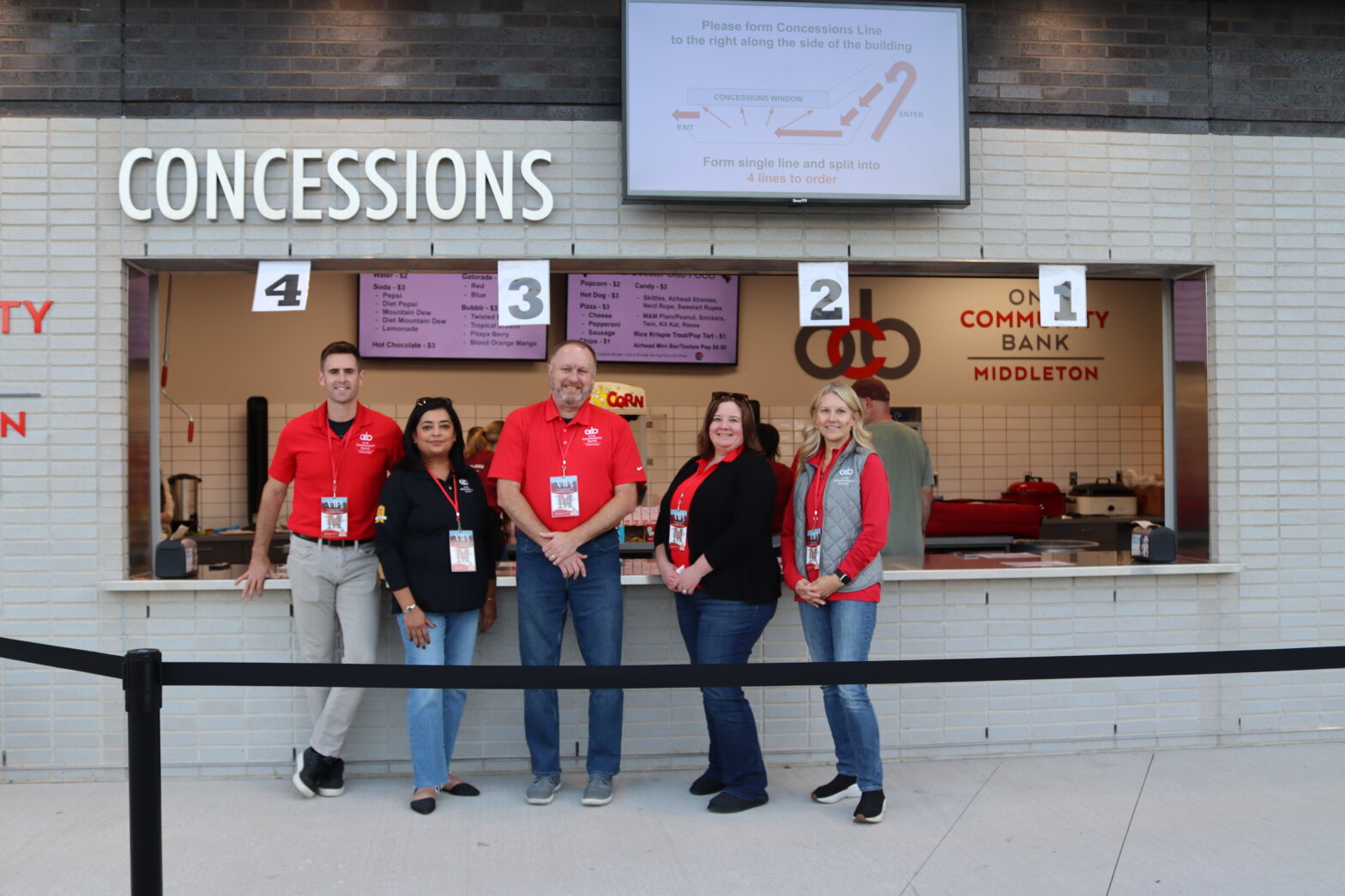 ocb colleagues in front of the Middleton High School Concession Stand