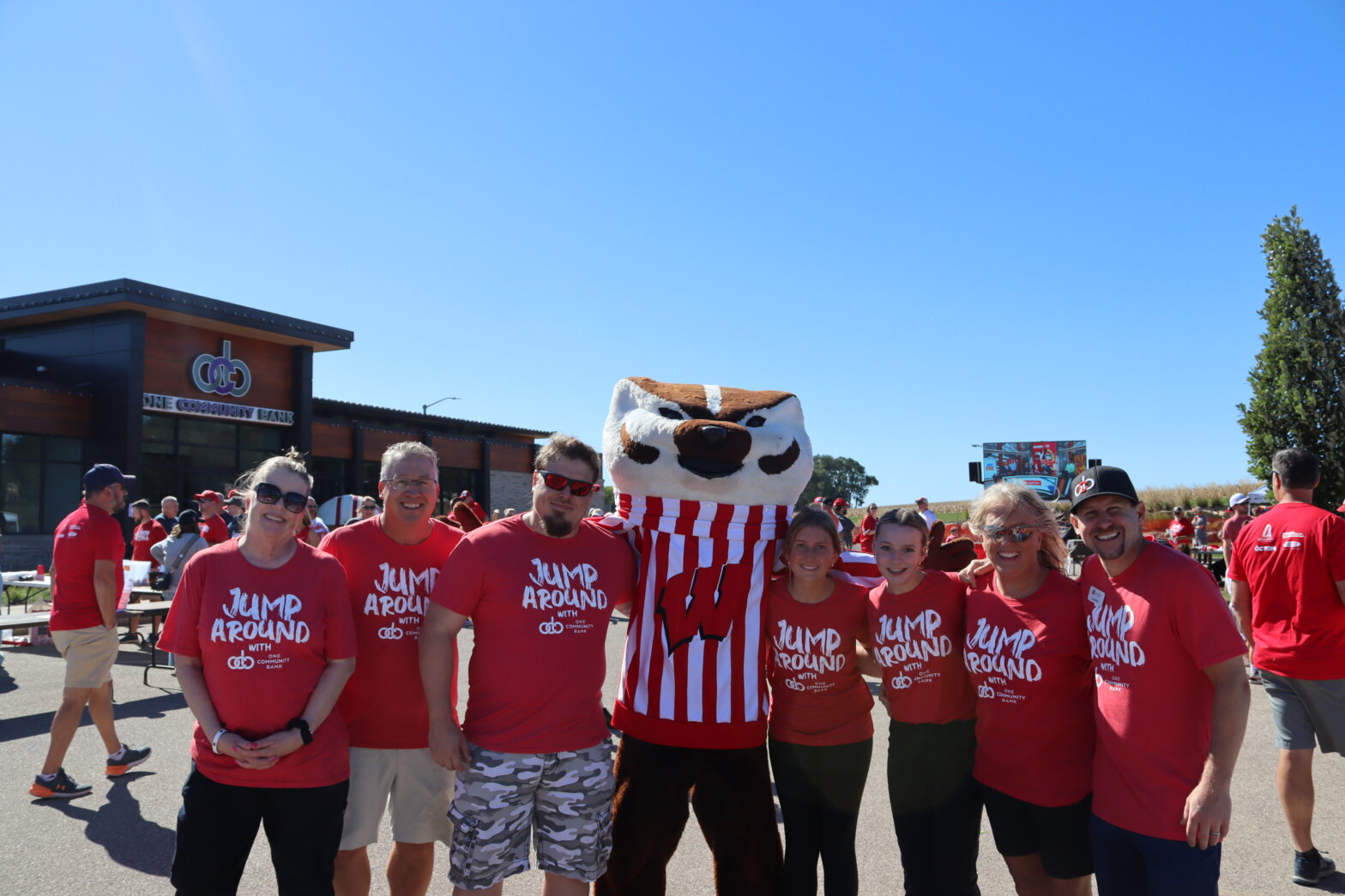 group of people standing with Bucky Badger